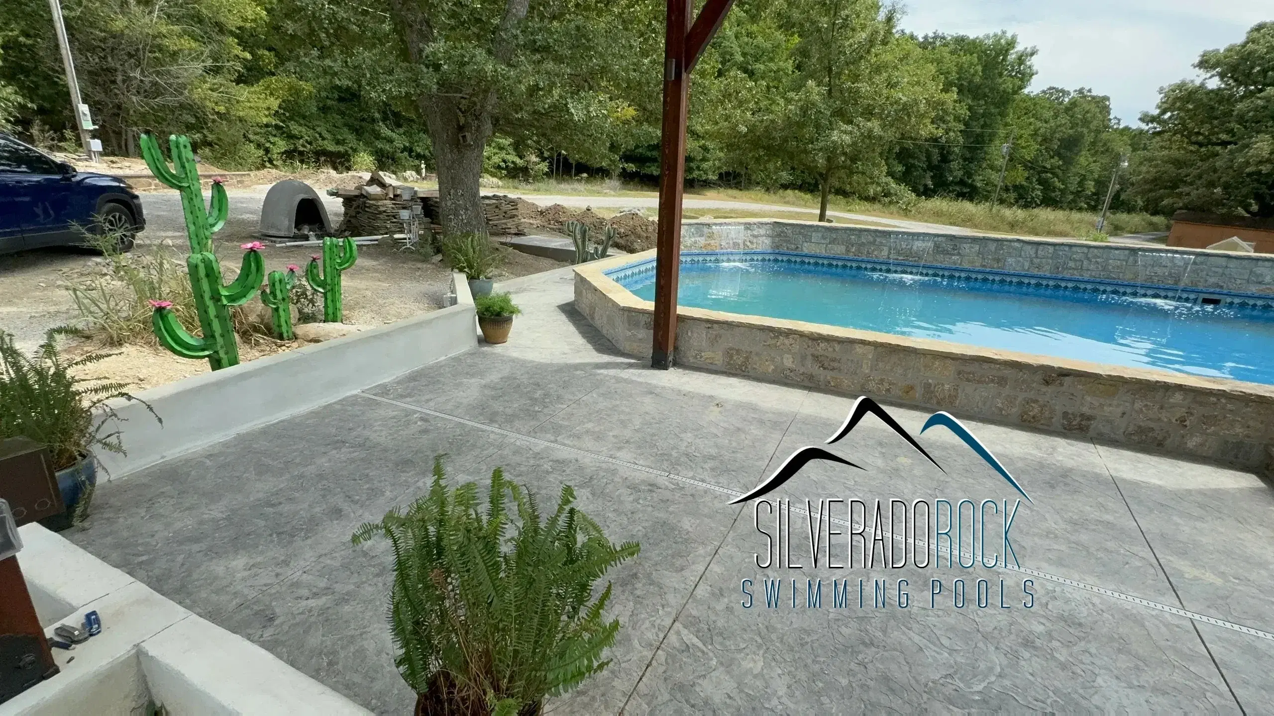 Installed freeform pool with stamped concrete decking — Tulsa, OK
