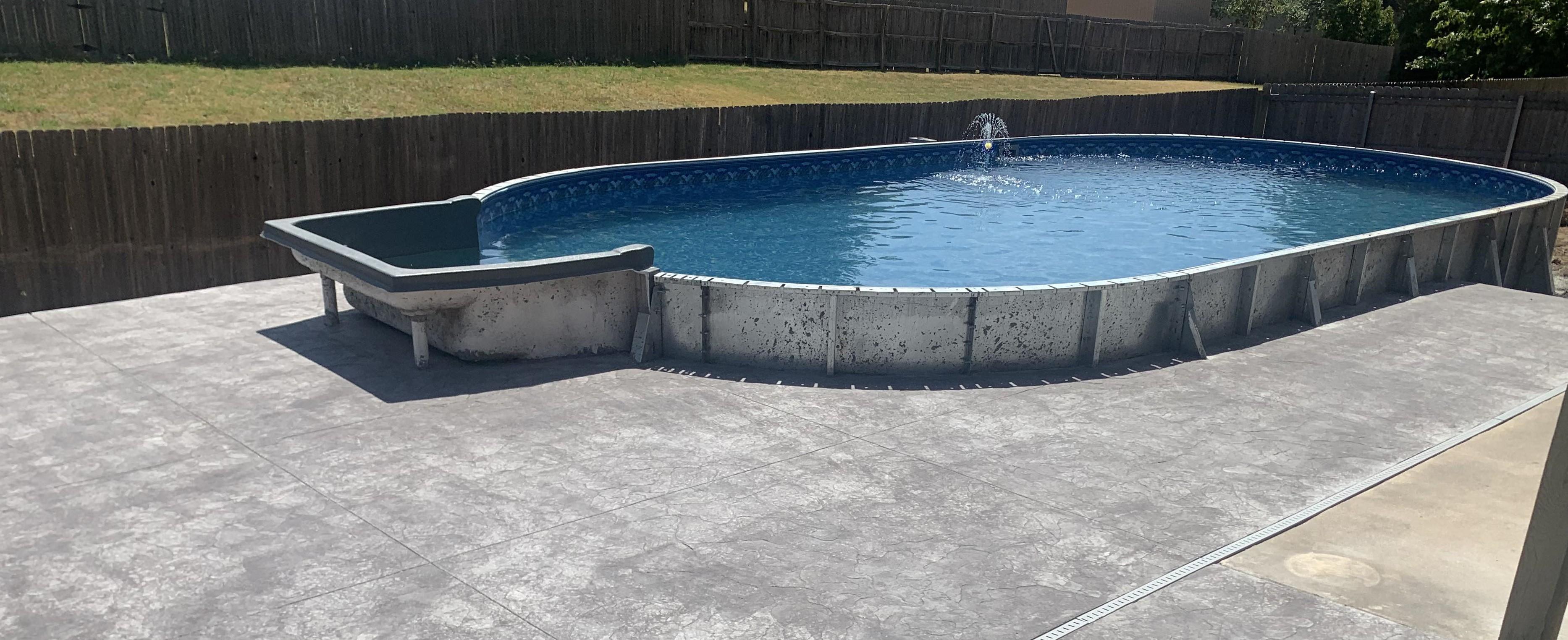 Compact plunge pool installed in a Tulsa backyard with lawn and seating area remaining
