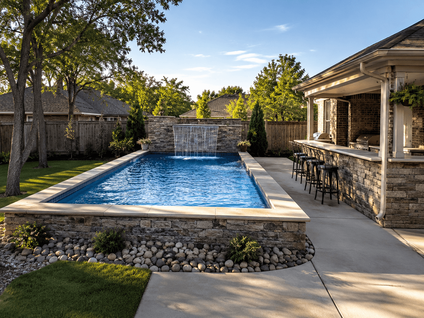 Custom inground pool with natural rock waterfall built by Silverado Rock Pools in Bixby, OK