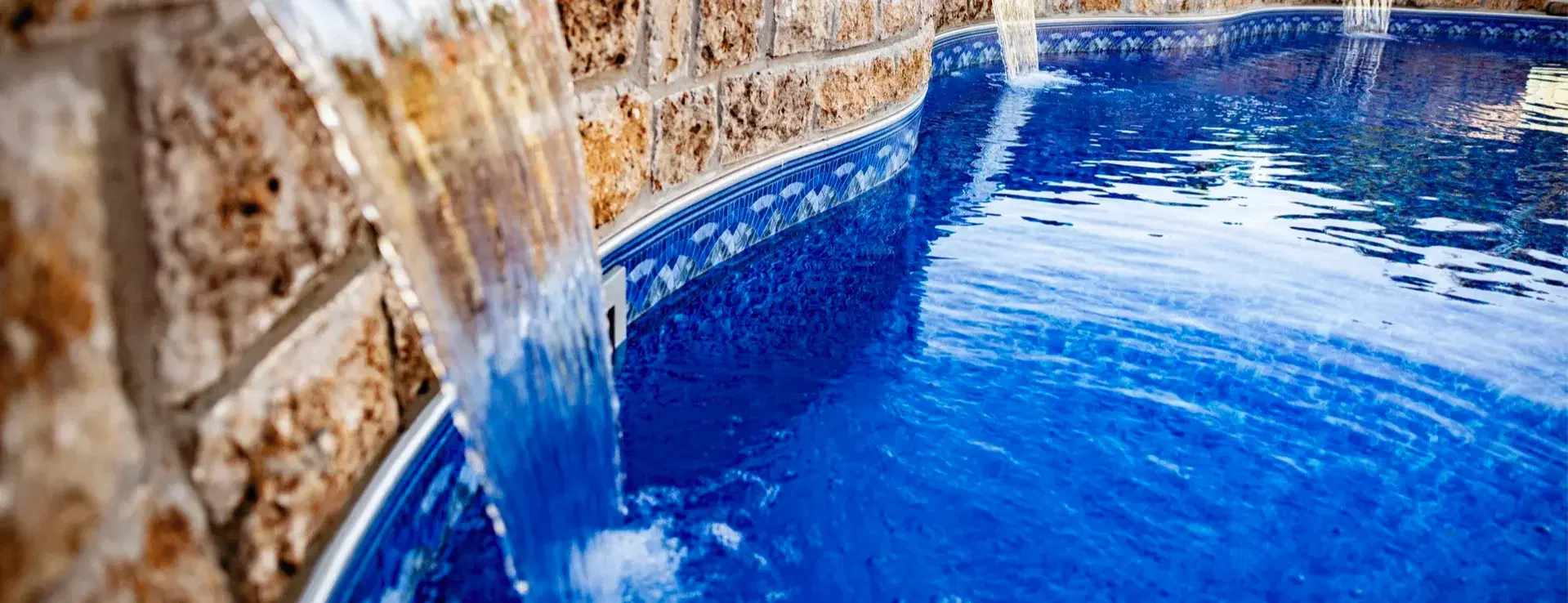 Custom inground pool with rock waterfall built by Silverado Rock in Tulsa, Oklahoma